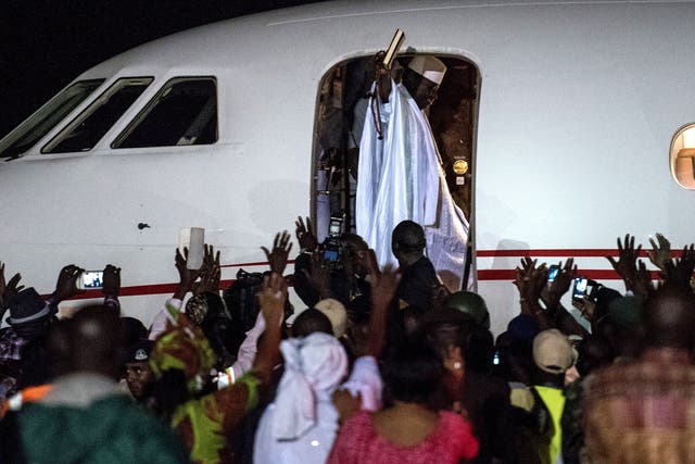 Ex-President Yahya Jammeh waves to a crowd of supporters before leaving the country on 21 January, 2017