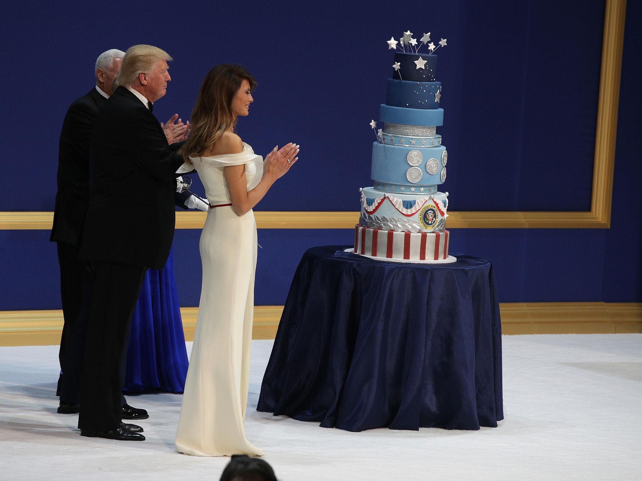 President Donald Trump, Melania Trump, Vice President Mike Pence and Karen Pence clap before cutting the cake during the inaugural ball at the National Building Museum