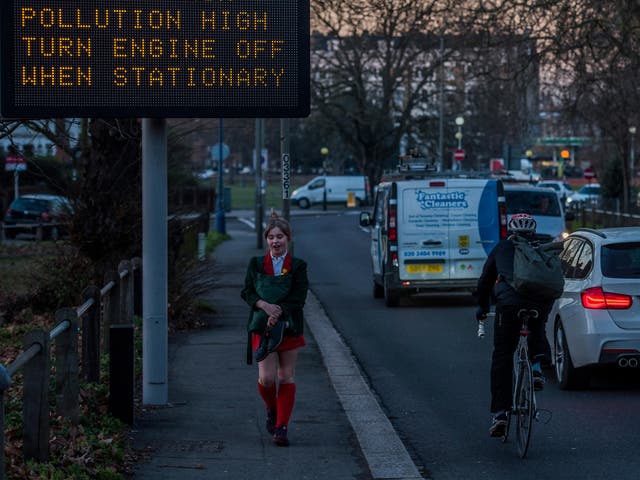 In Wandsworth, a sign warns of high pollution as evening rush hour begins