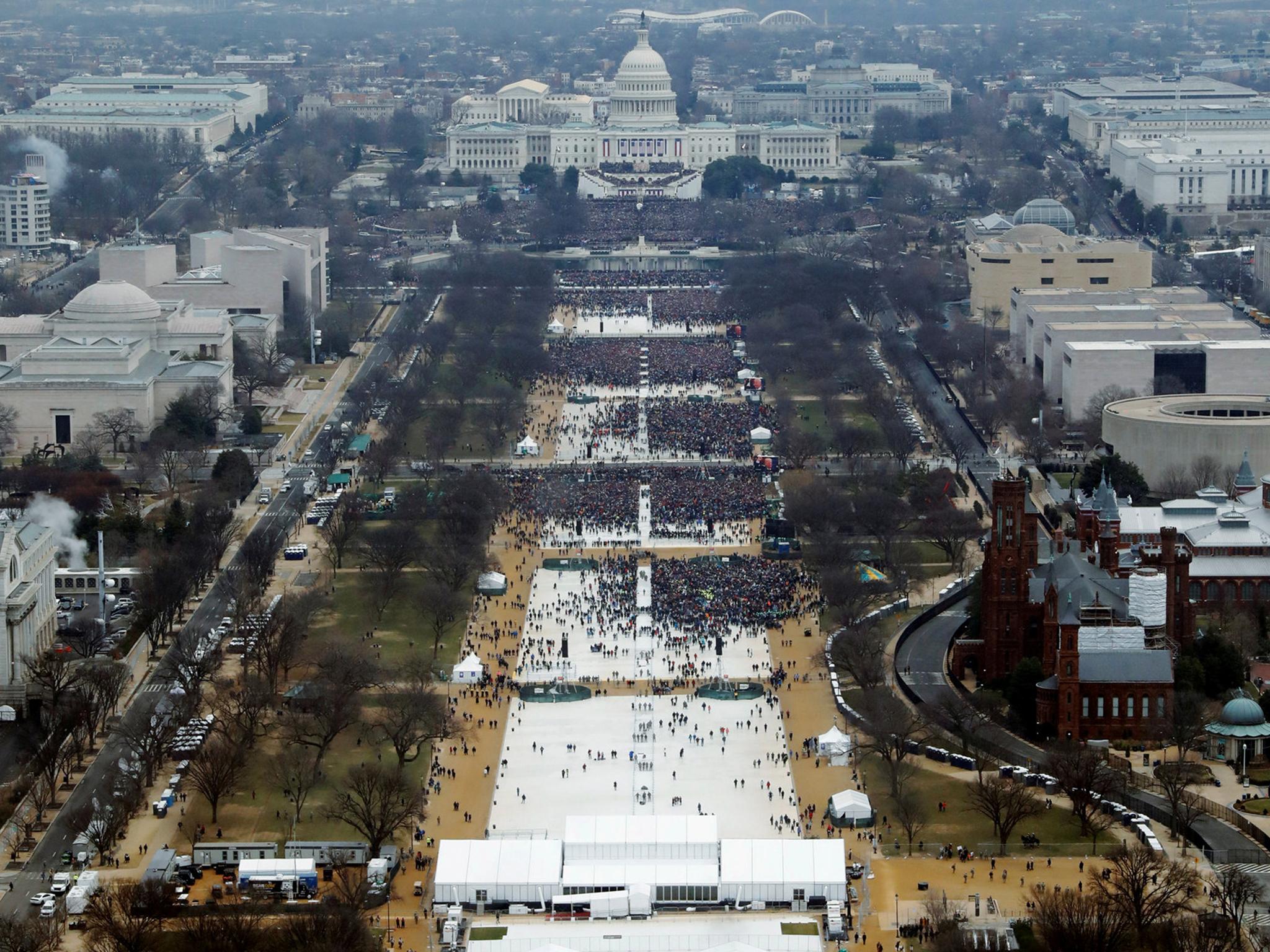 Crowds attending the inauguration ceremonies to swear in U.S. President Donald Trump at 12:01pm (L) on January 20, 2017 a