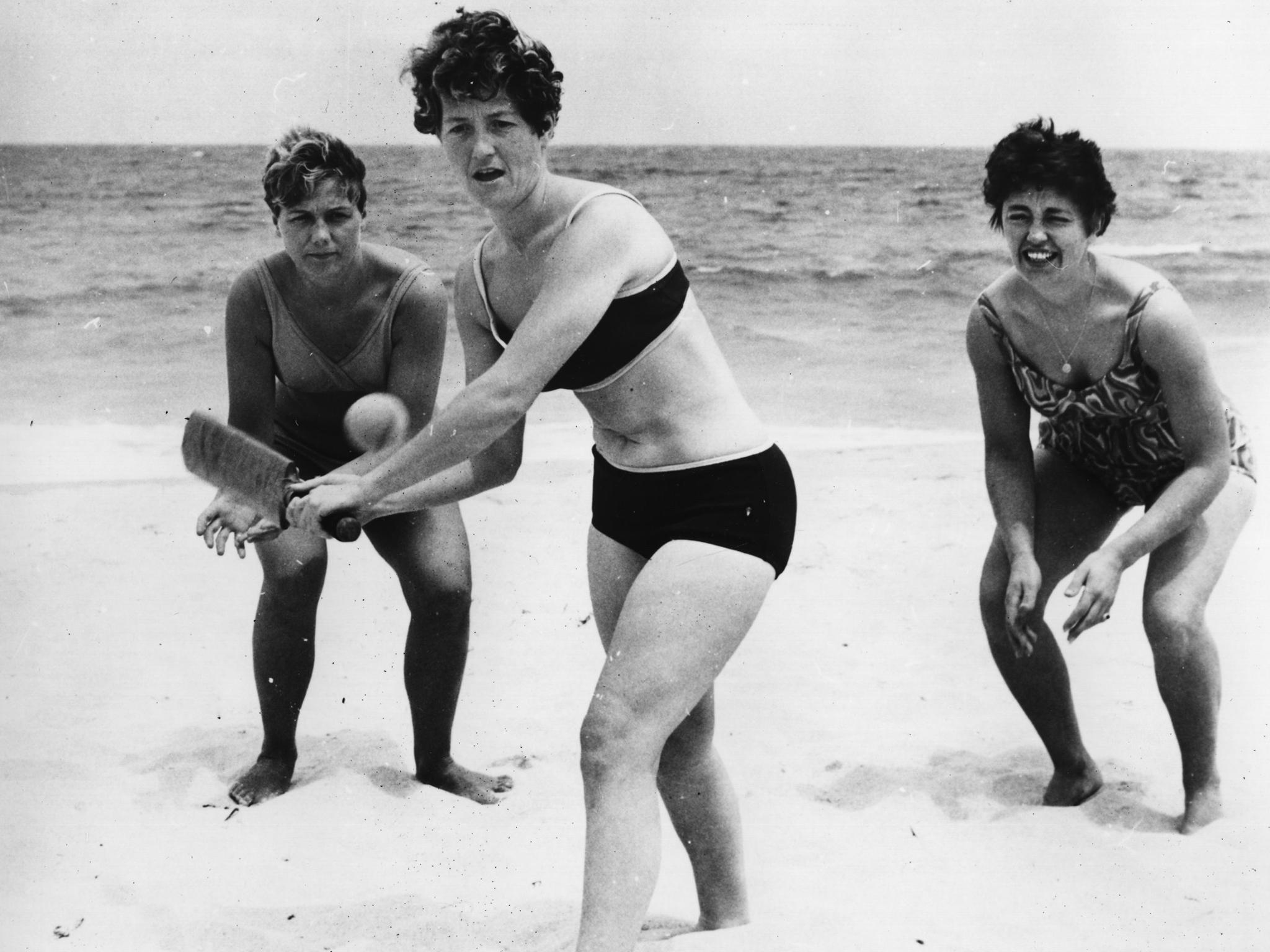 English cricketers Rachael Heyhoe Flint (batting), Edna Barker, left, and Audrey Disbury practising on Perth beach during their tour of Australia