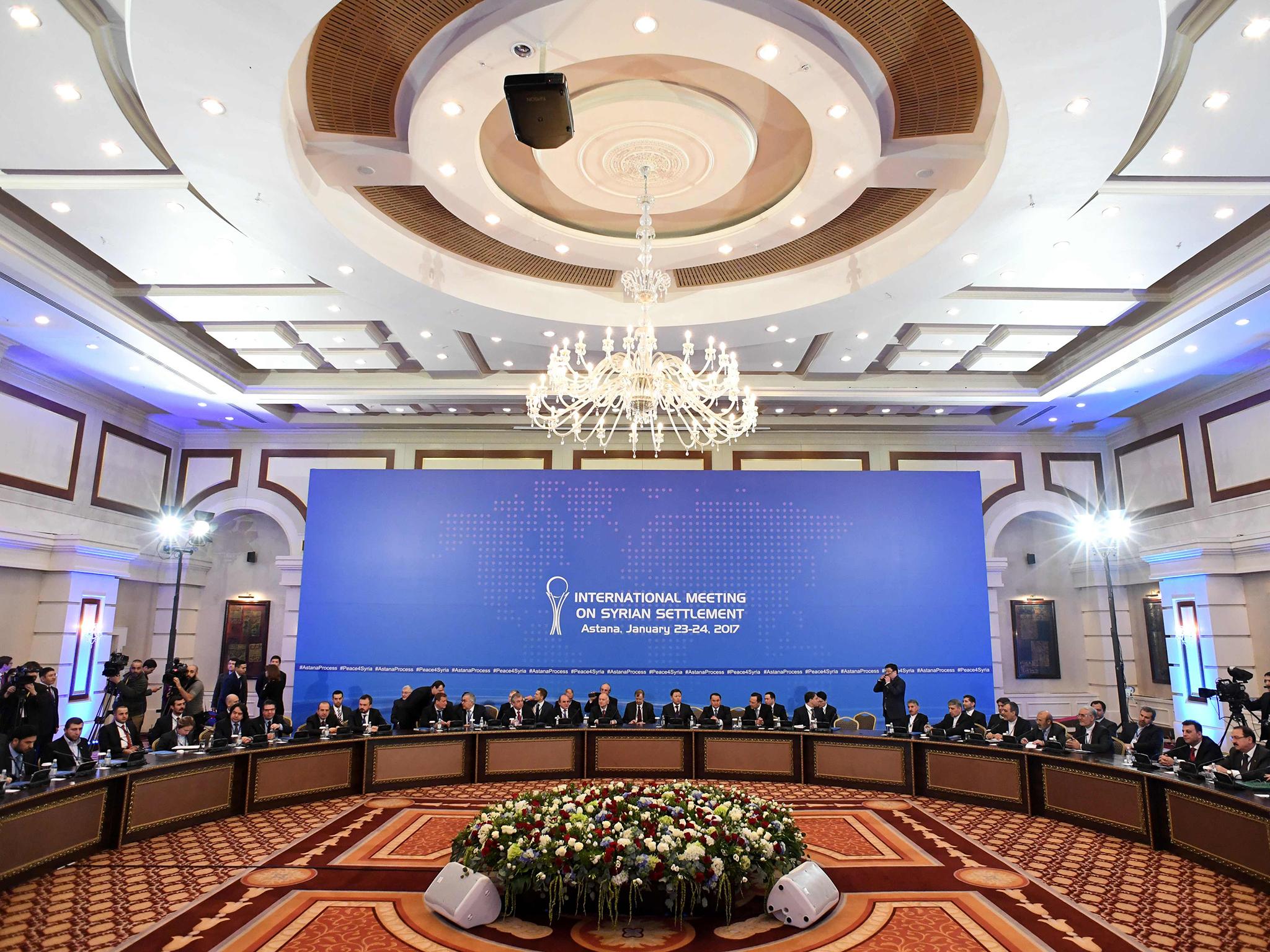 Representatives of the Syria regime and rebel groups along with other attendees take part in the first session of Syria peace talks at Astana's Rixos President Hotel