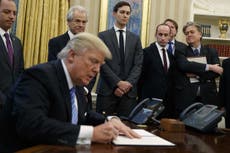 Trump reinstates global abortion funding ban surrounded by men