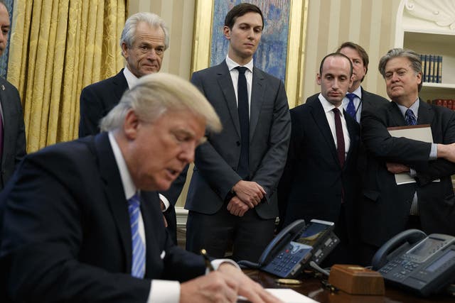From left, White House Chief of Staff Reince Priebus, National Trade Council adviser Peter Navarro, Senior Adviser Jared Kushner, policy adviser Stephen Miller, and chief strategist Steve Bannon watch as President Donald Trump signs an executive order in the Oval Office of the White House