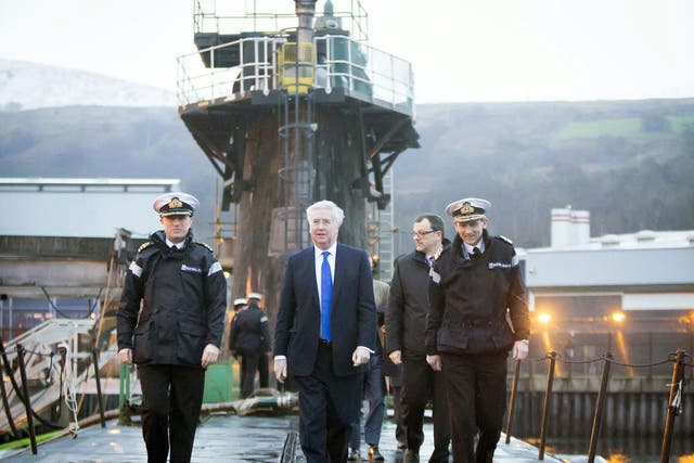 Defence Secretary Michael Fallon, seen here atop a Trident nuclear submarine, has said Jeremy Corbyn is "gutless" for opposing military expansion