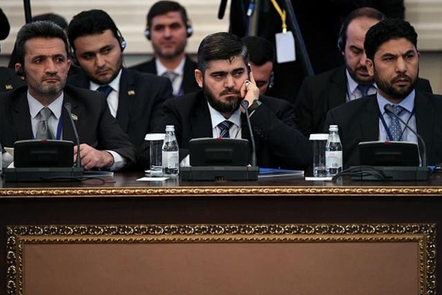 Chief opposition negotiator Mohammad Alloush (C) of the Jaish al-Islam (Army of Islam) rebel group attends the first session of Syria peace talks at Astana's Rixos President Hotel on January 23, 2017