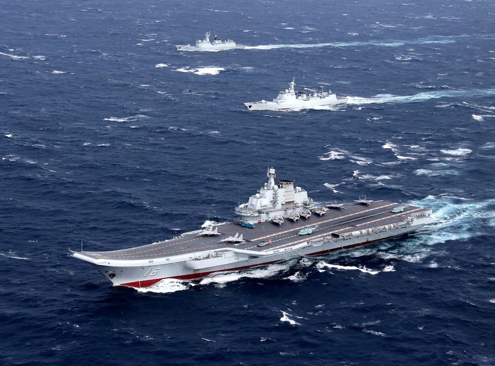 China's Liaoning aircraft carrier with accompanying fleet conducts a drill in an area of South China Sea