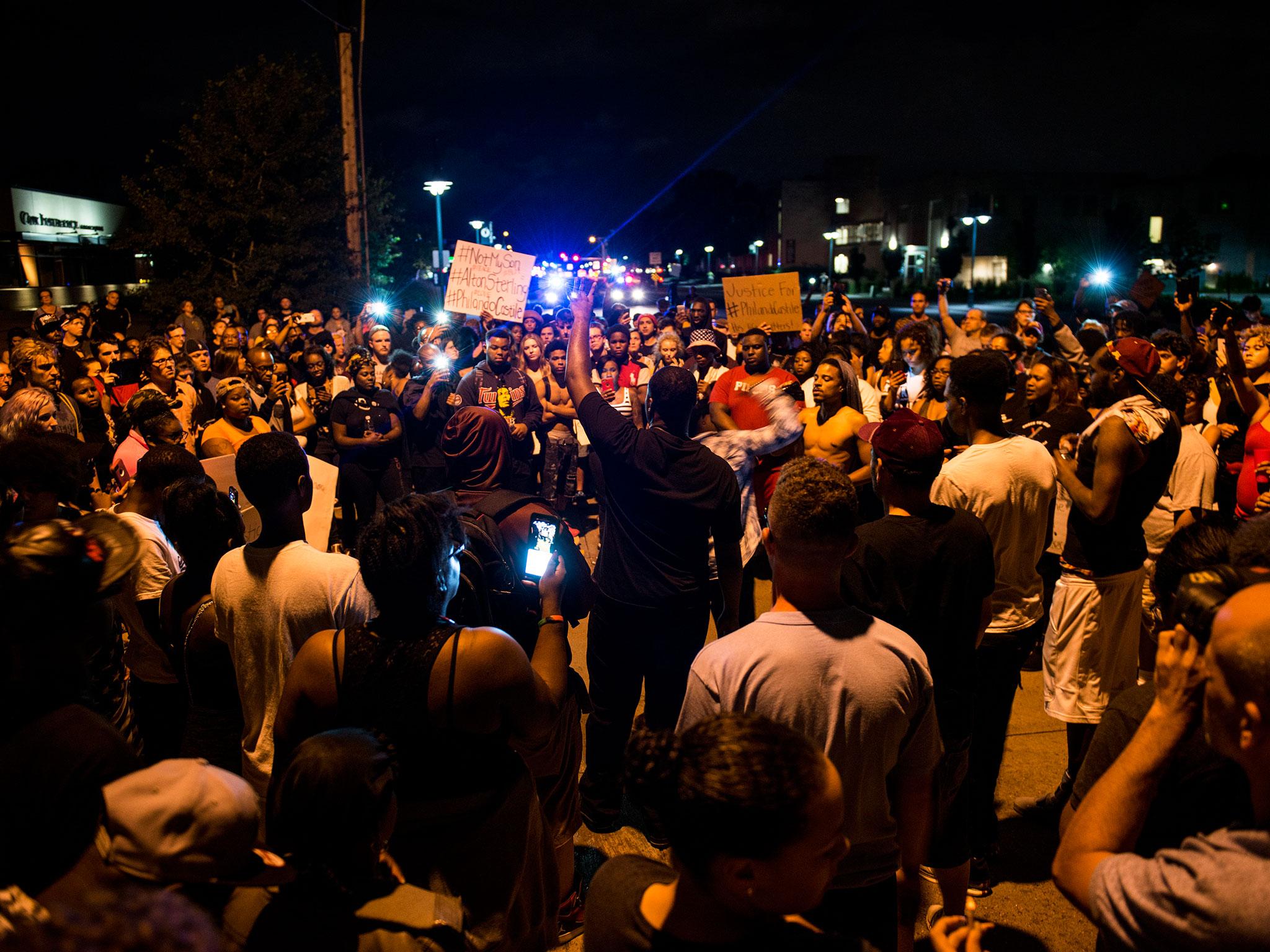 Protestors gather at the intersection where Philando Castile was shot on 7 July, 2016 in Falcon Heights, Minnesota