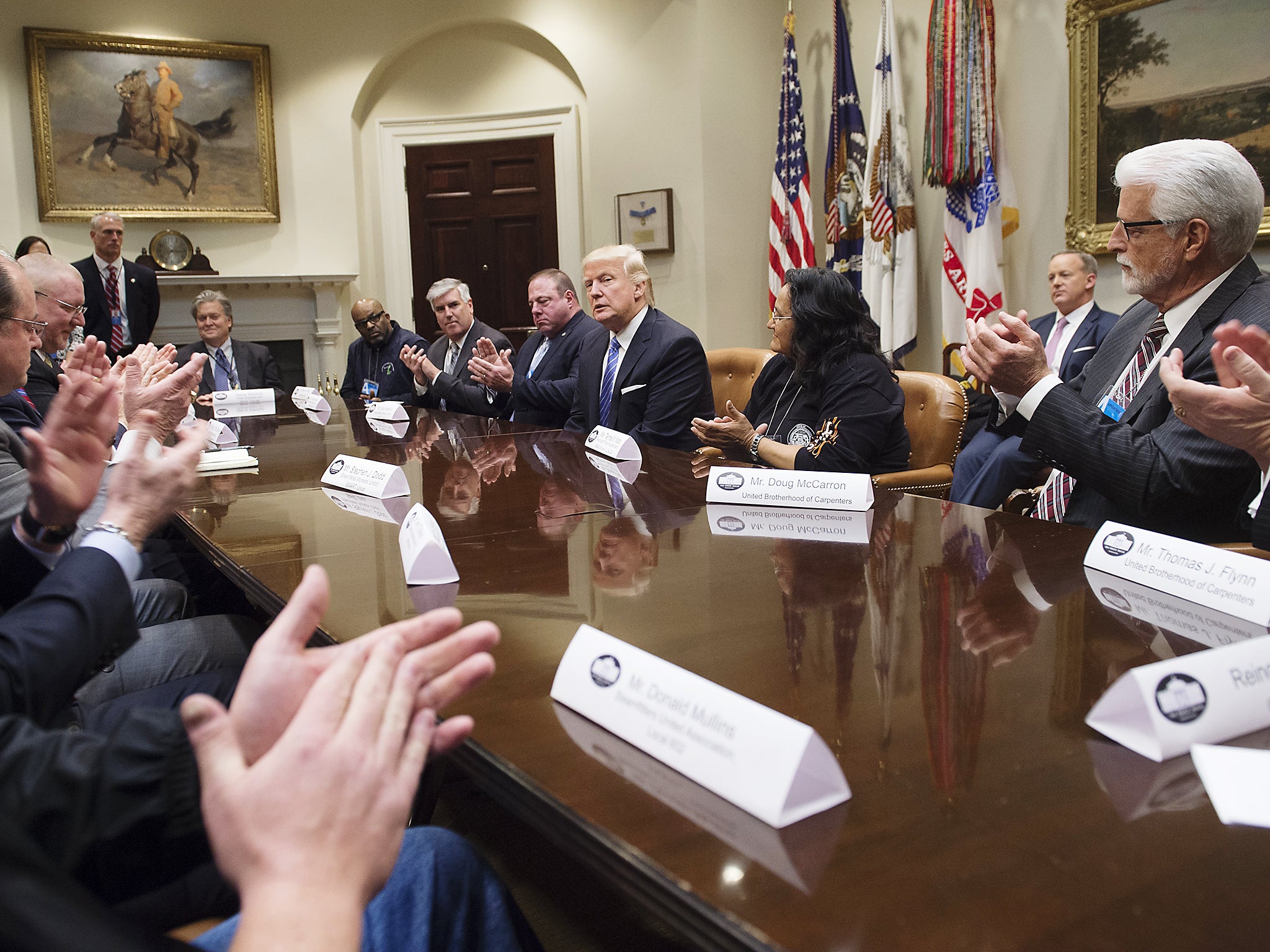 Union leaders applaud US President Donald Trump for signing an executive order withdrawing the US from the Trans-Pacific Partnership negotiations during a meeting in the Roosevelt Room of the White House in Washington DC (Getty Images)