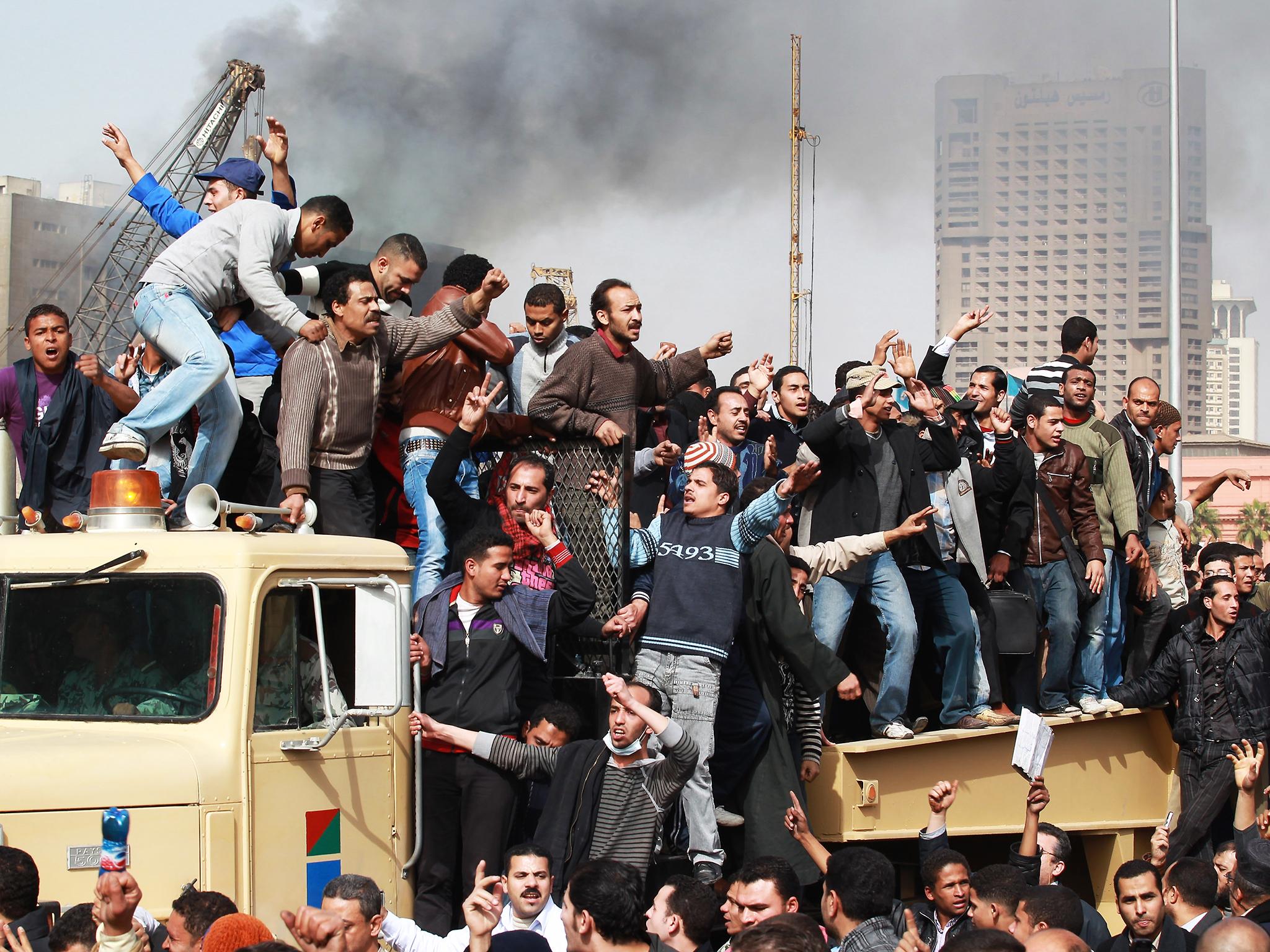 Protestors chant as they ride on an army tank transporter in Cairo’s?Tahrir Square in January?2011