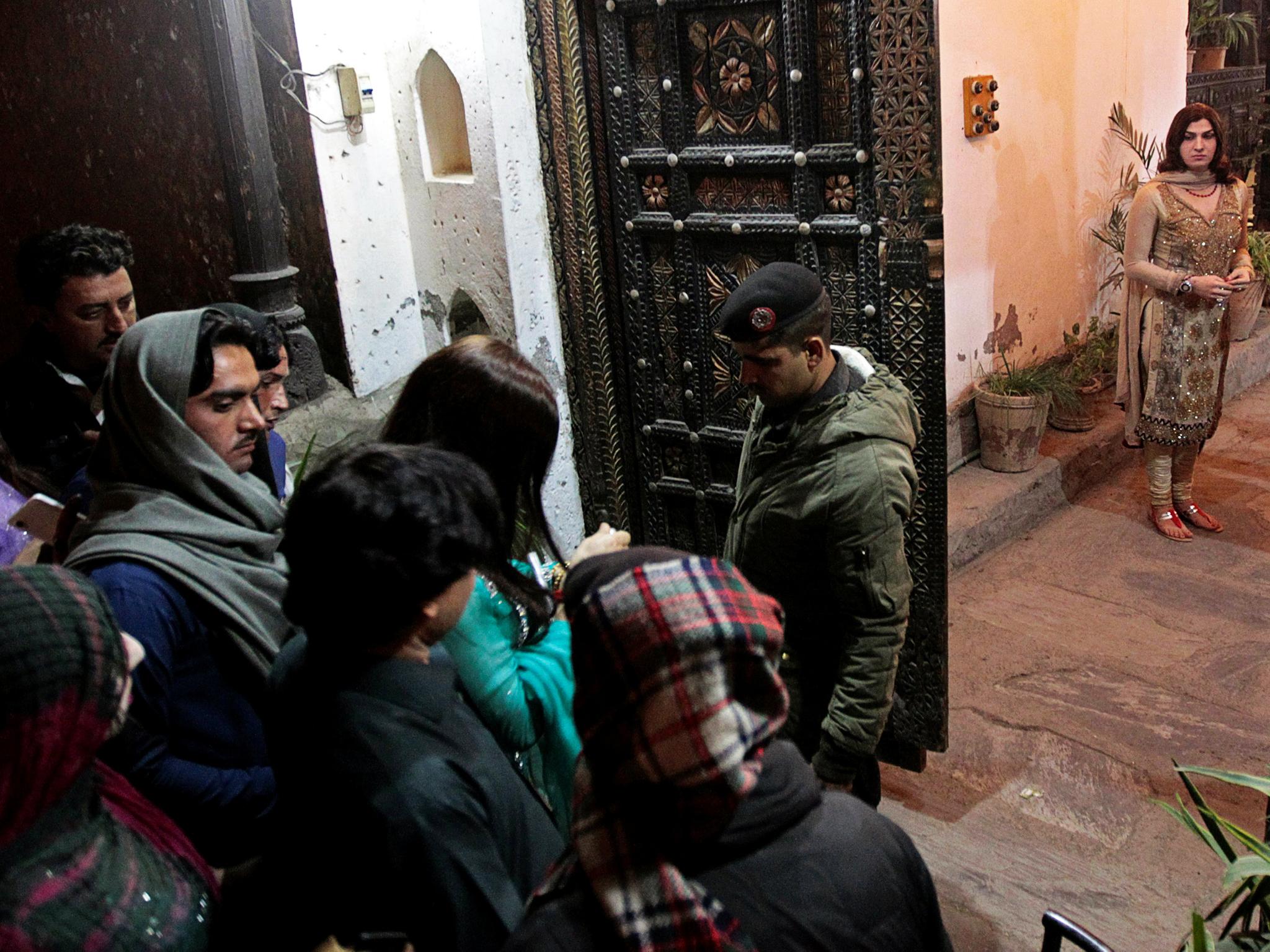 Security searches guests as people arrive at Shakeela's party in Peshawar, Pakistan