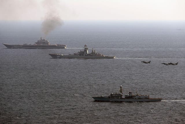 HMS St Albans (foreground), escorting Russian Warships Petr Velikiy (centre) and the Admiral Kuznetsov (background), as they pass through the English Channel on their way back to Russia