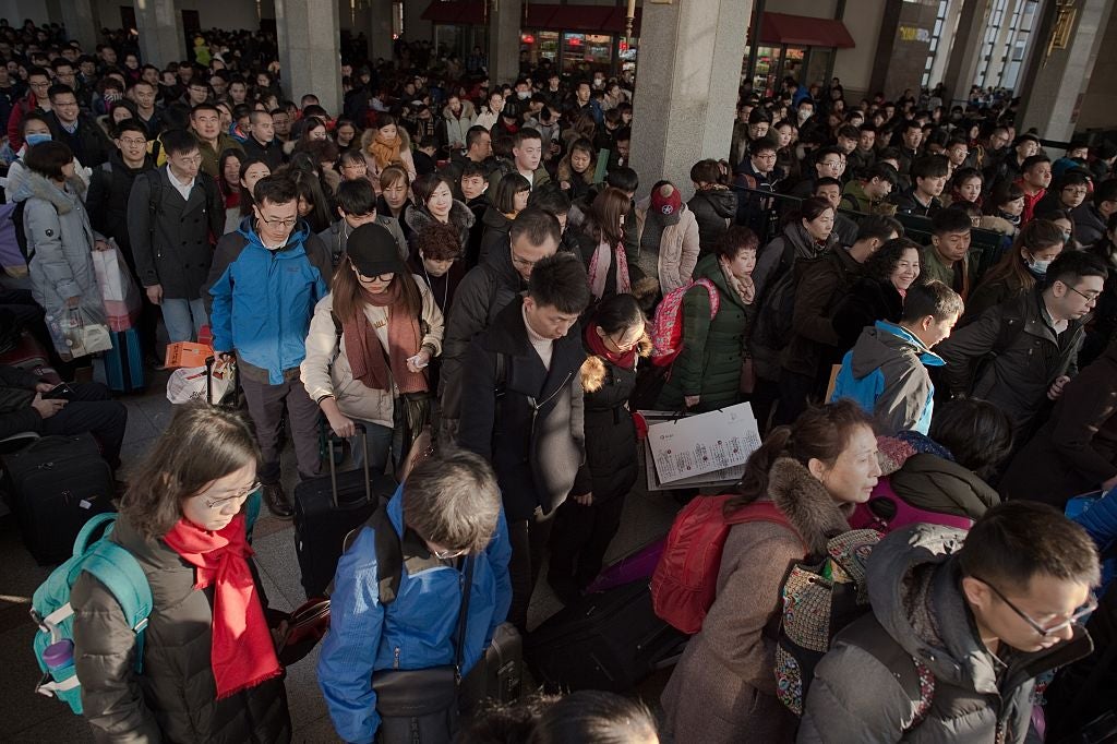 Passengers arrive at Beijing Railway Station to travel to their hometowns for the Lunar New Year on 24 January