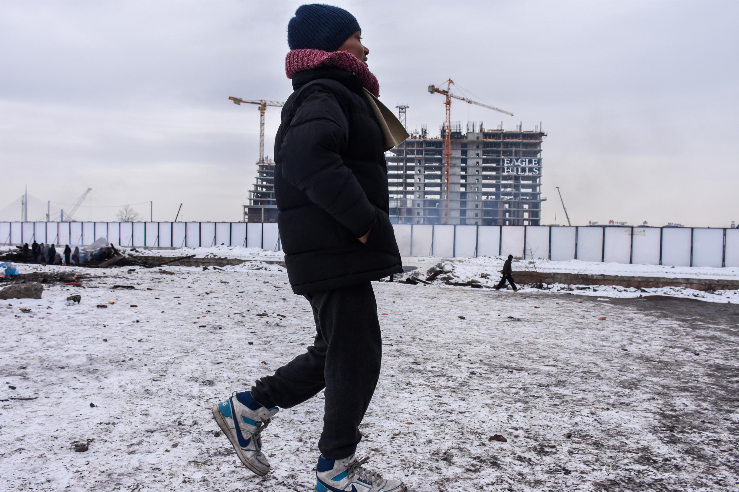 A homeless refugee boy in Belgrade endures freezing conditions