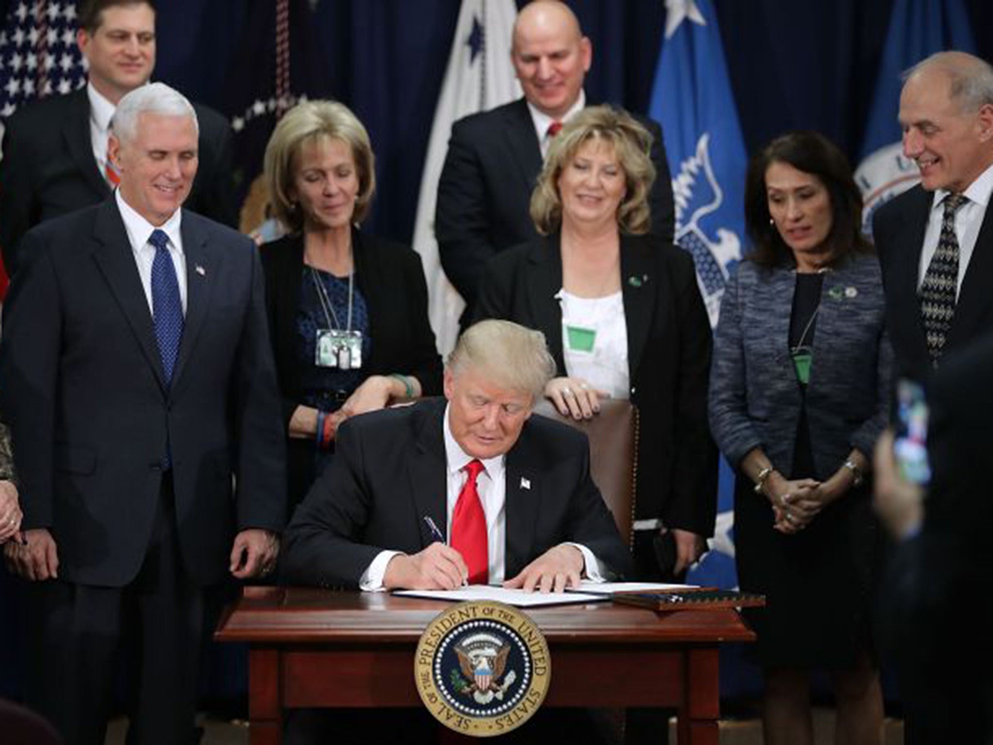 The US President signed a number of his most extreme immigration policies into law on Wednesday