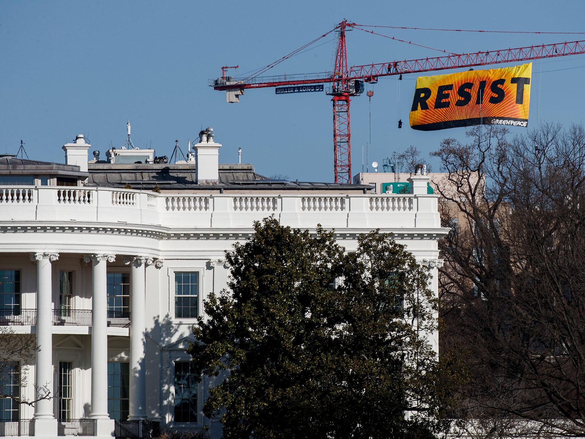 Greenpeace hang giant 'Resist' banner next to White House ...