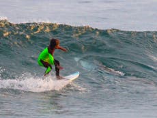 Great white shark photographed metres from 10-year-old surfer