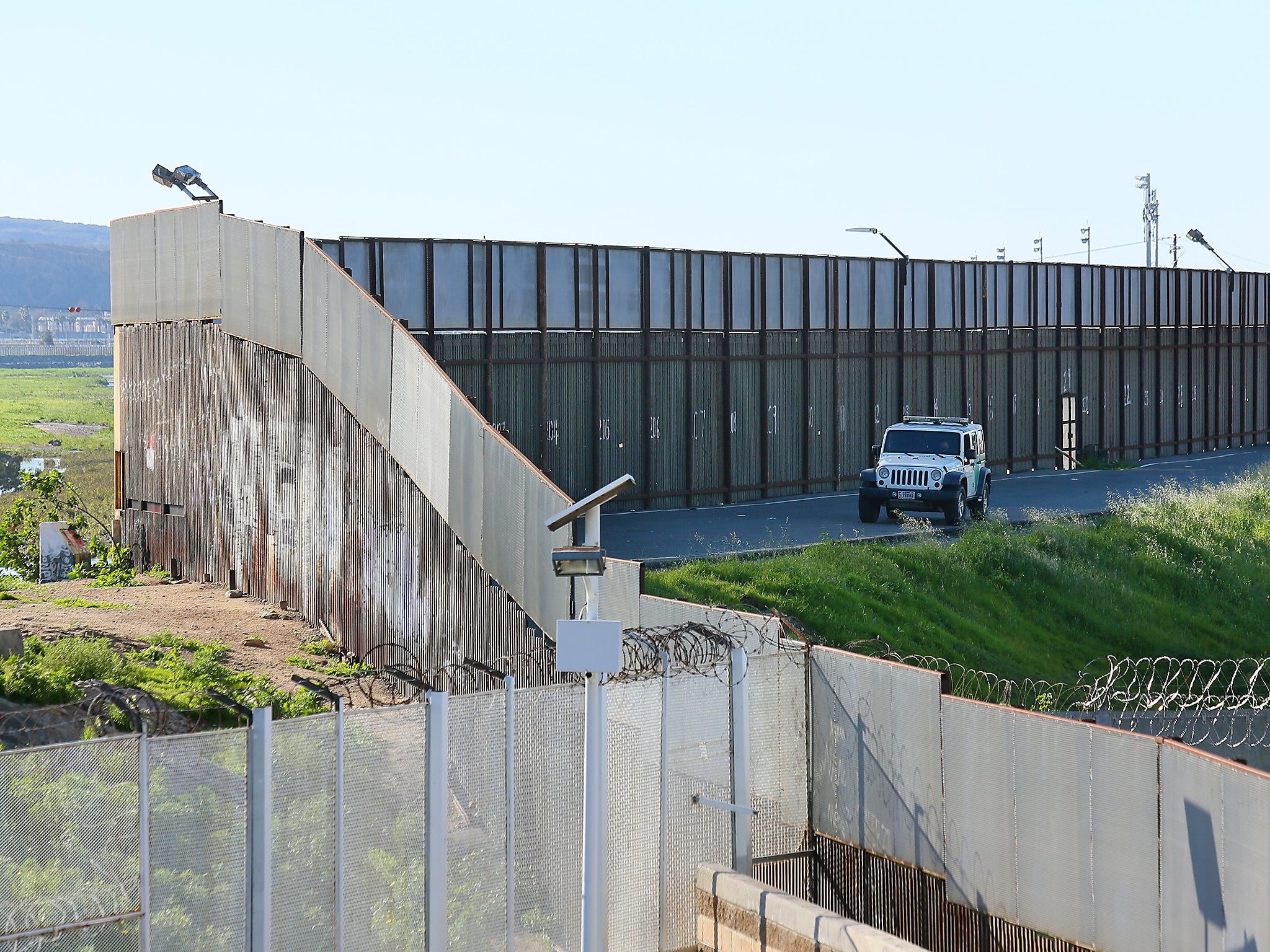 A Border Patrol vehicle sits along the US-Mexico border wall in San Ysidro, California