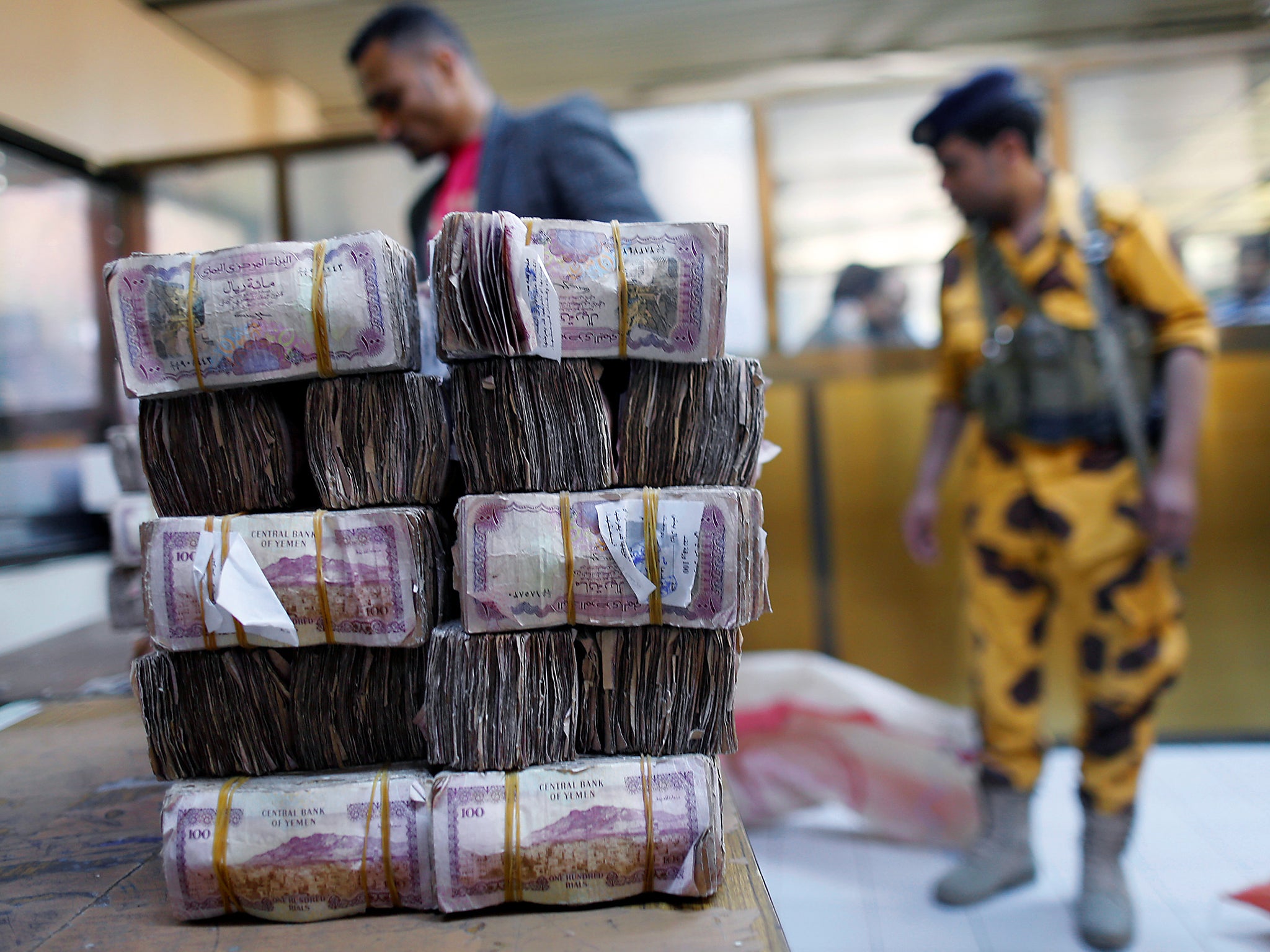 Bundles of Yemeni currency are pictured at a post office before being handed to public sector employees as salaries in Sanaa