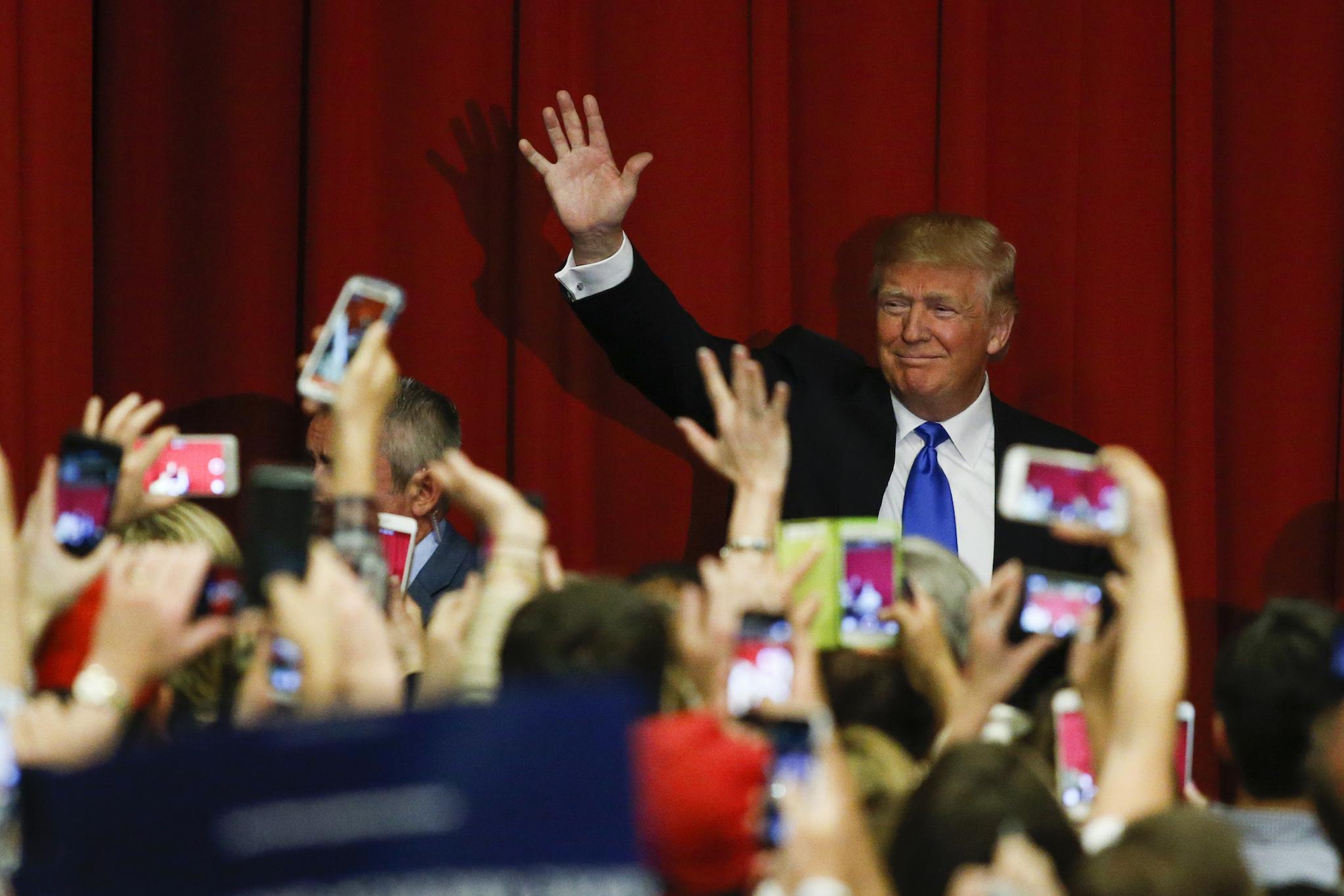Republican presidential candidate Donald Trump waves to the crowd at a fundraising event