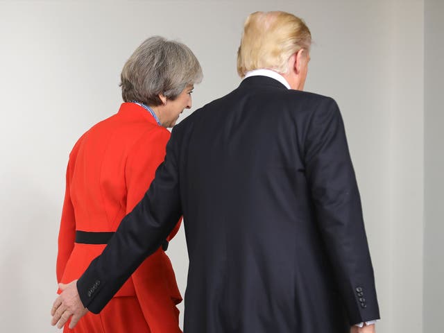 Prime Minister Theresa May with U.S. President Donald Trump as they walk along The Colonnade at The White House on January 27, 2017