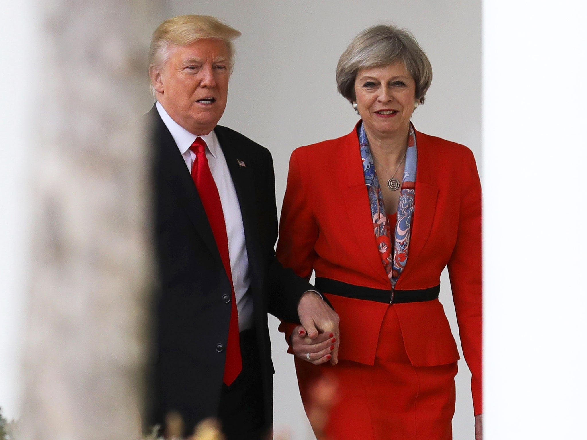 Prime Minister Theresa May with US President Donald Trump walk along The Colonnade at The White House on January 27, 2017