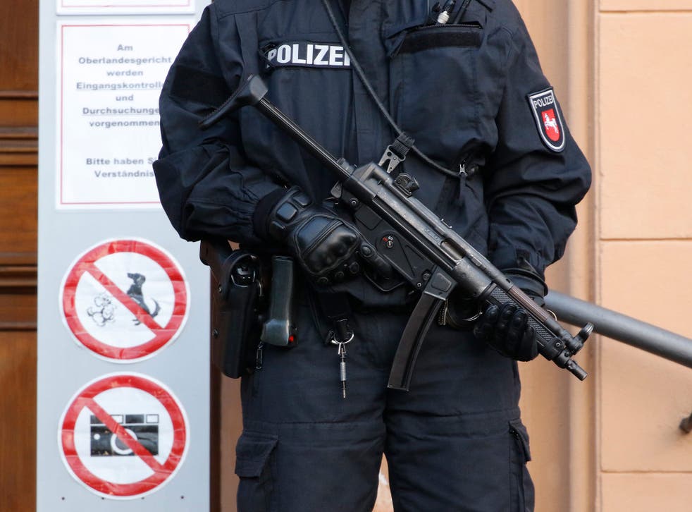 An armed police officer stands at the entrance of the court in Celle, northern Germany