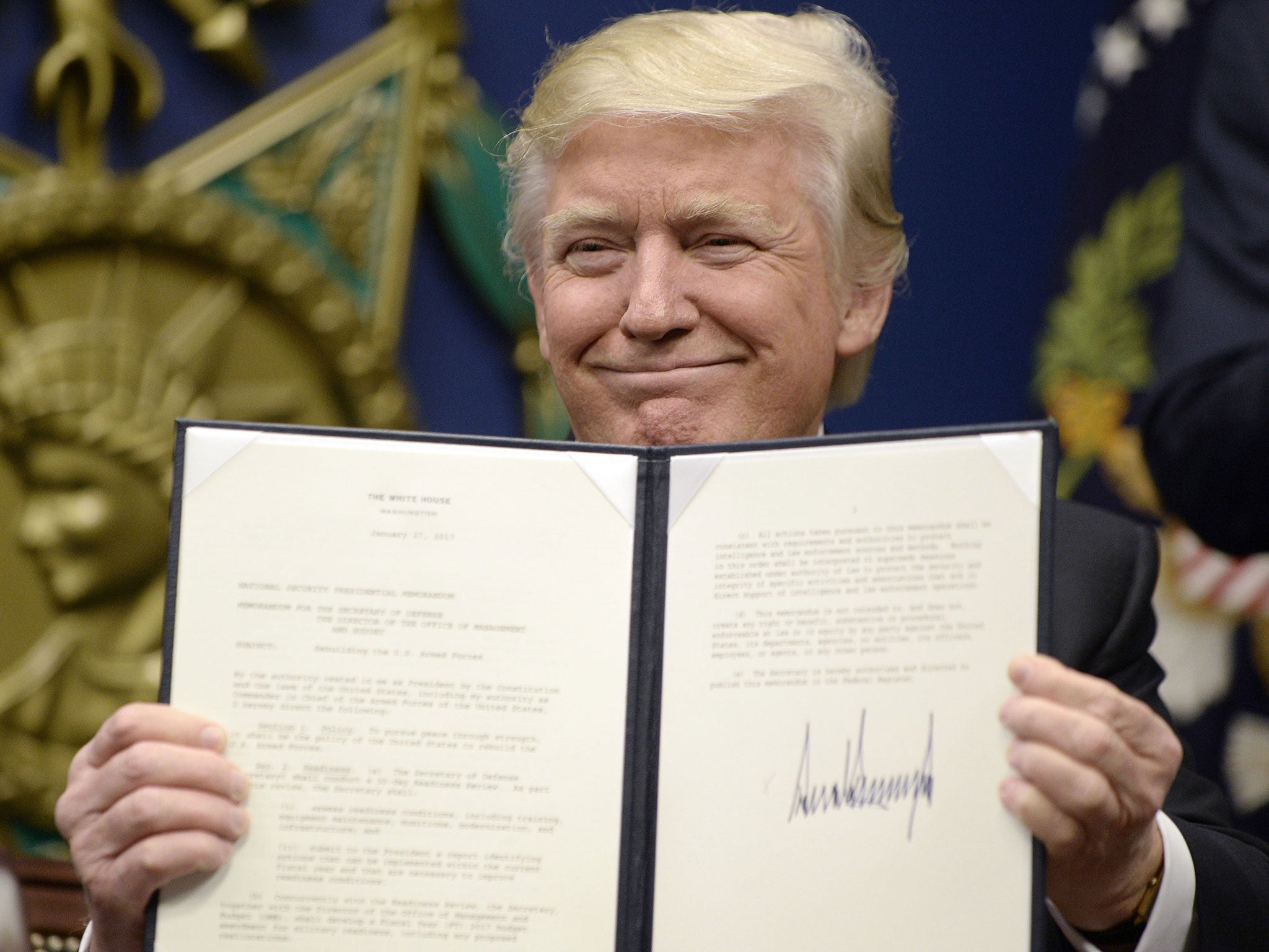 President Donald Trump signs an executive order on the 'extreme vetting' of visa seekers from terror-plagued countries