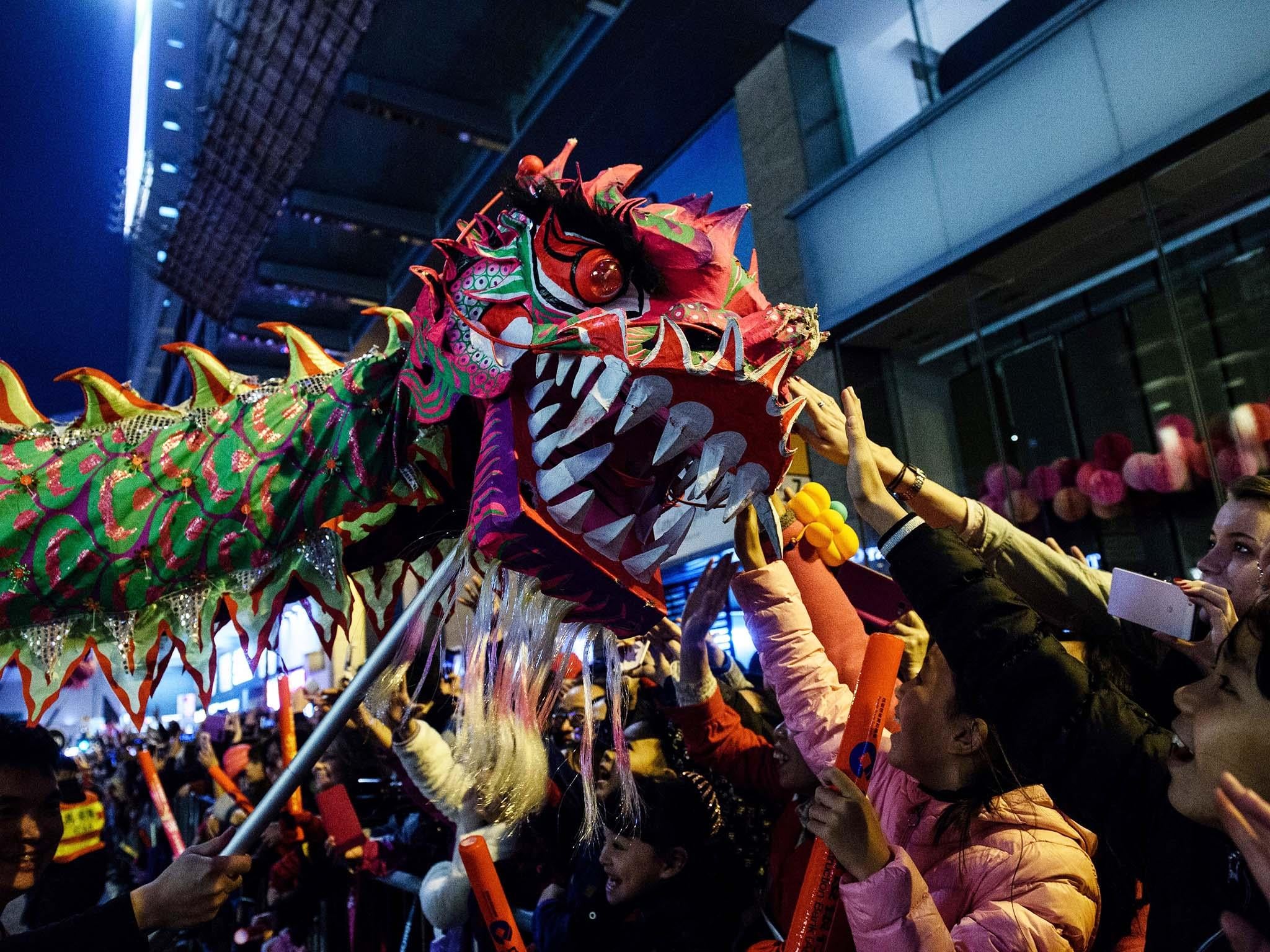 Crowds celebrate Chinese New Year, beginning the year of the fire rooster