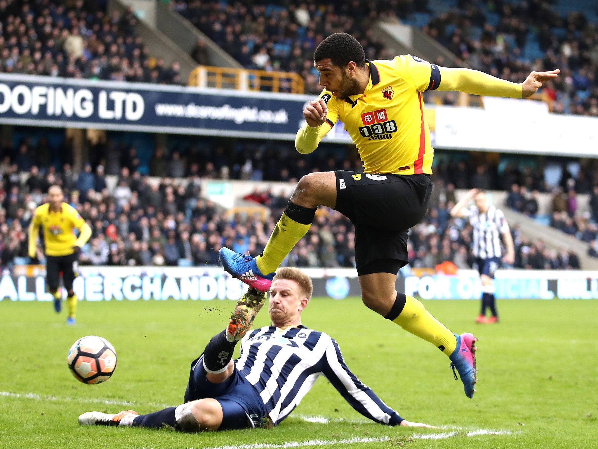 Byron Webster attempts to block a shot from Troy Deeney