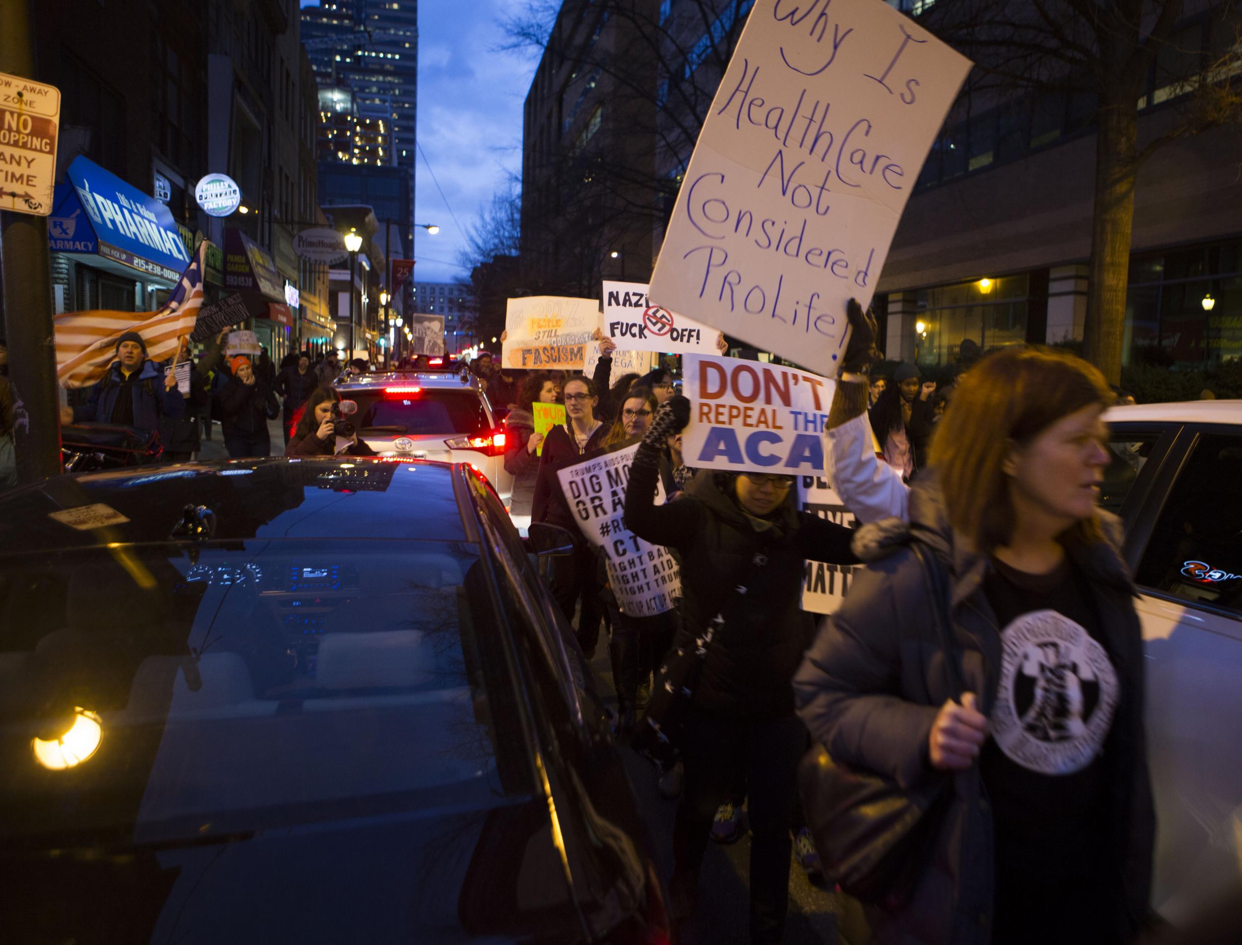 Protesters and activists march through downtown Philadelphia during the Republican retreat