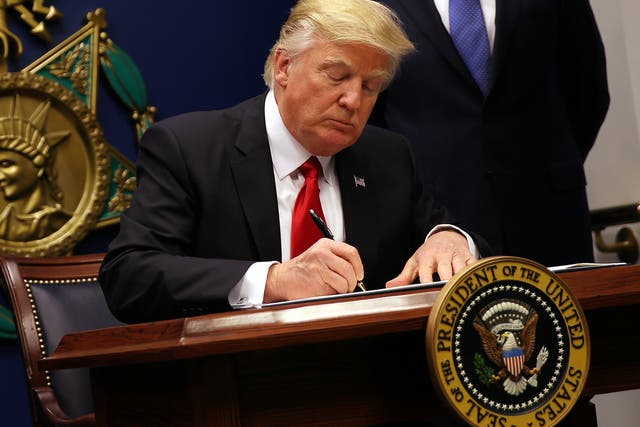 The US President signing an executive order to impose tighter vetting of travellers entering the country
