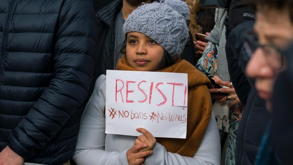 Protesters assemble at John F. Kennedy International Airport in New York on 28 January 2017 after two Iraqi refugees were detained while trying to enter the country