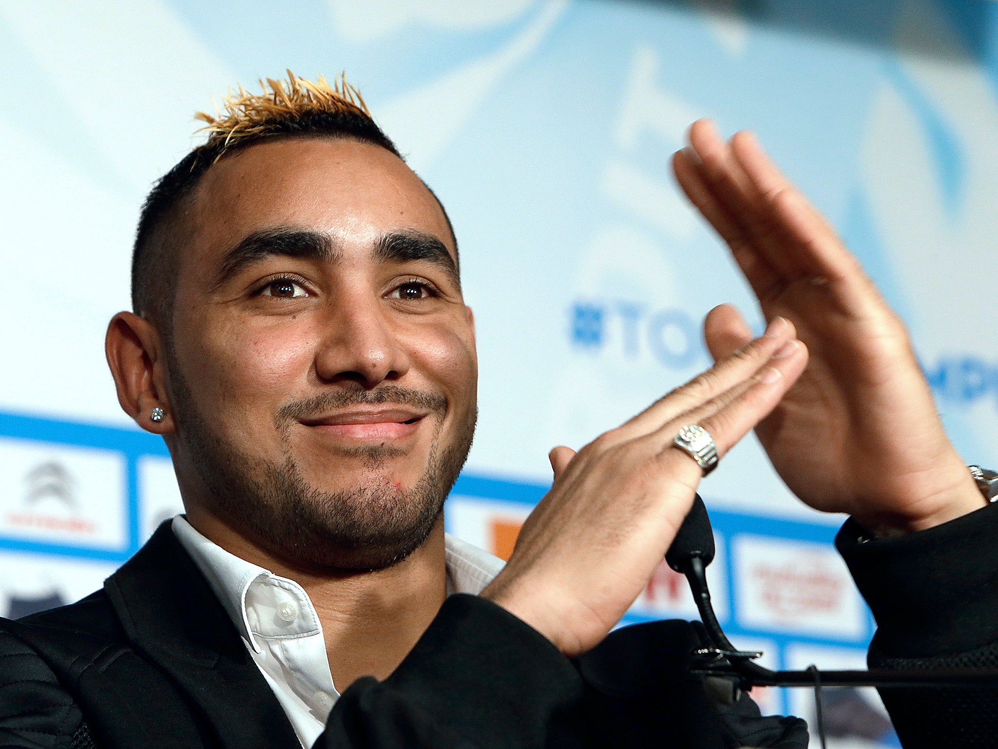 Olympique Marseille new player Dimitri Payet, gestures as he speaks with the media during a press conference, in Marseille