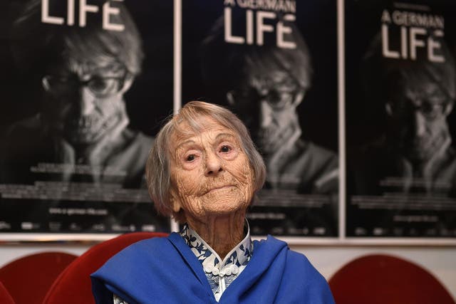 Brunhilde Pomsel, former secretary of Nazi propaganda chief Joseph Goebbels, sits on a cinema chair in front of posters for the movie 'A German life'
