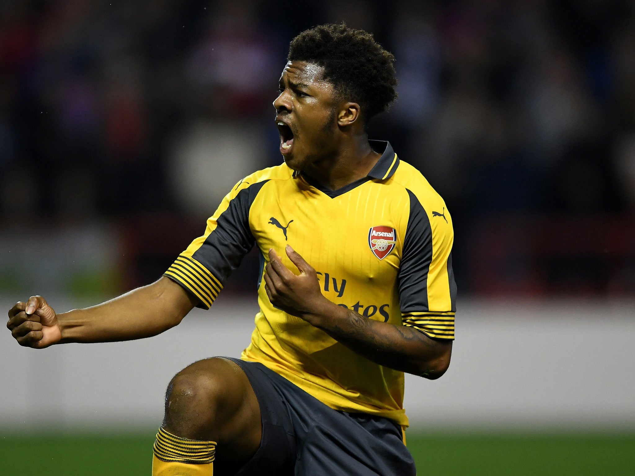 Akpom celebrates after winning a penalty which lead to his sides second goal during the EFL Cup Third Round match between Nottingham Forest and Arsenal at City Ground on September 20, 2016