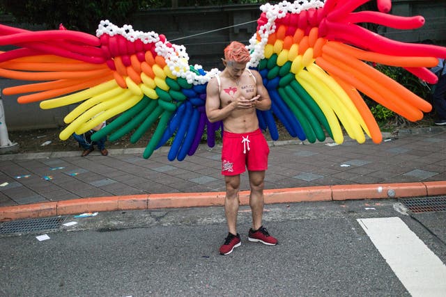 A man wears a pair of wings made with balloons during the annual Taiwan lesbian, gay, bisexual and transgender pride parade in Taipei