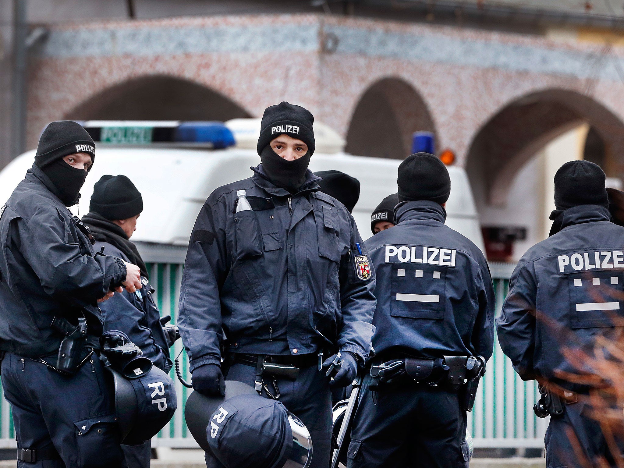 German police officers stand guard in front of a mosque during a terror raid in Frankfurt, Germany, on 1 February