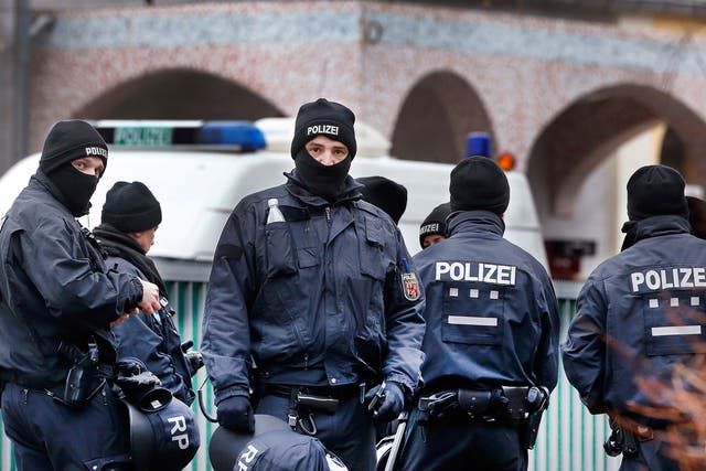 German police officers stand guard in front of a mosque during a terror raid in Frankfurt, Germany, on 1 February