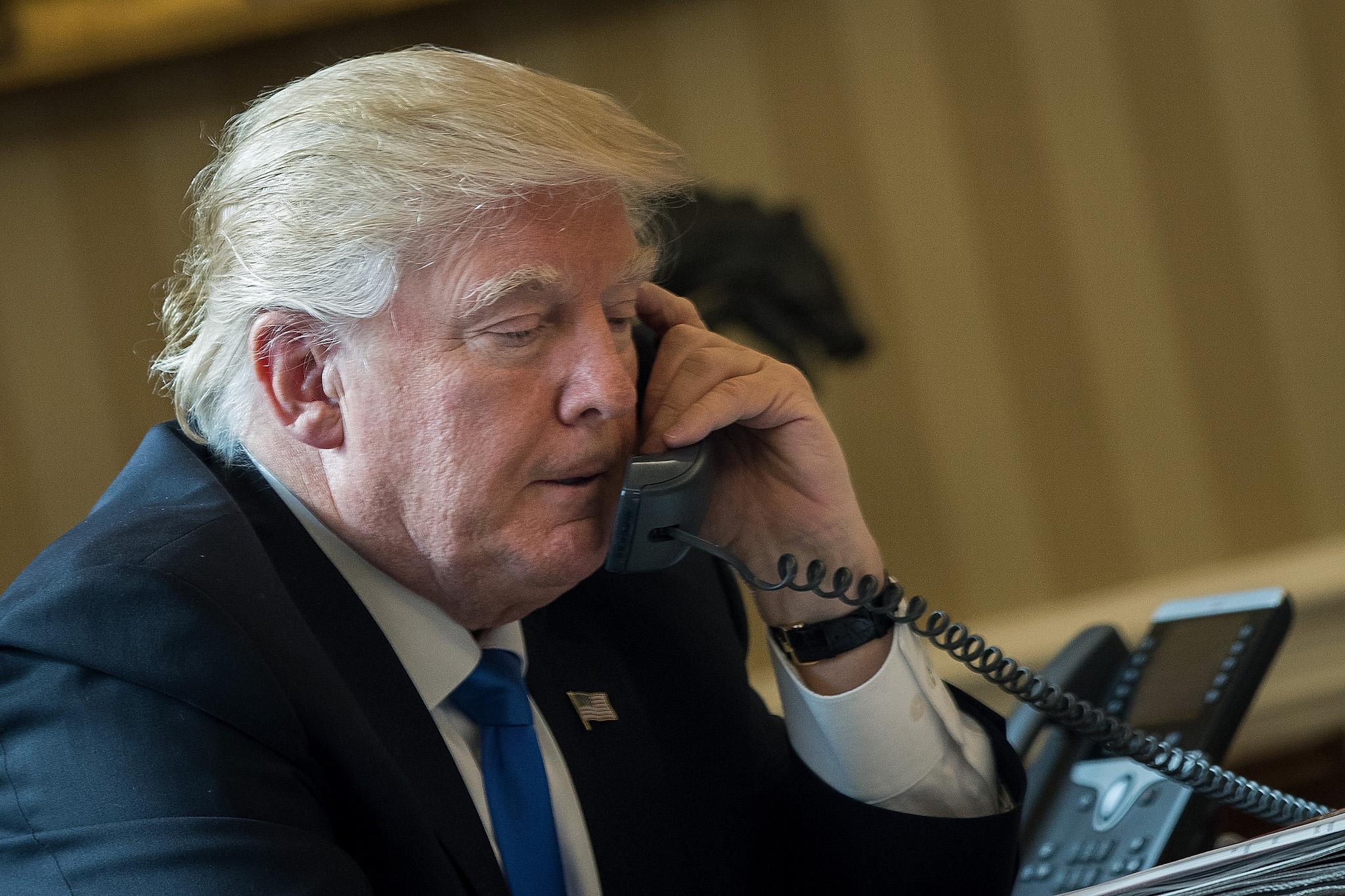 President Donald Trump speaks on the phone with Russian President Vladimir Putin in the Oval Office of the White House