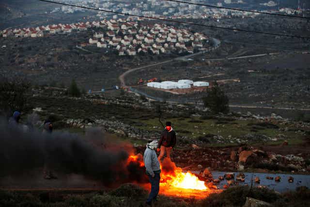 Protesters burn tires at the entrance to the Israeli settler outpost of Amona in the occupied West Bank early in the morning of February 1, 2017  