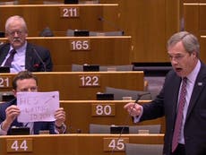 Nigel Farage interrupted mid-speech by MEP holding 'he's lying' sign