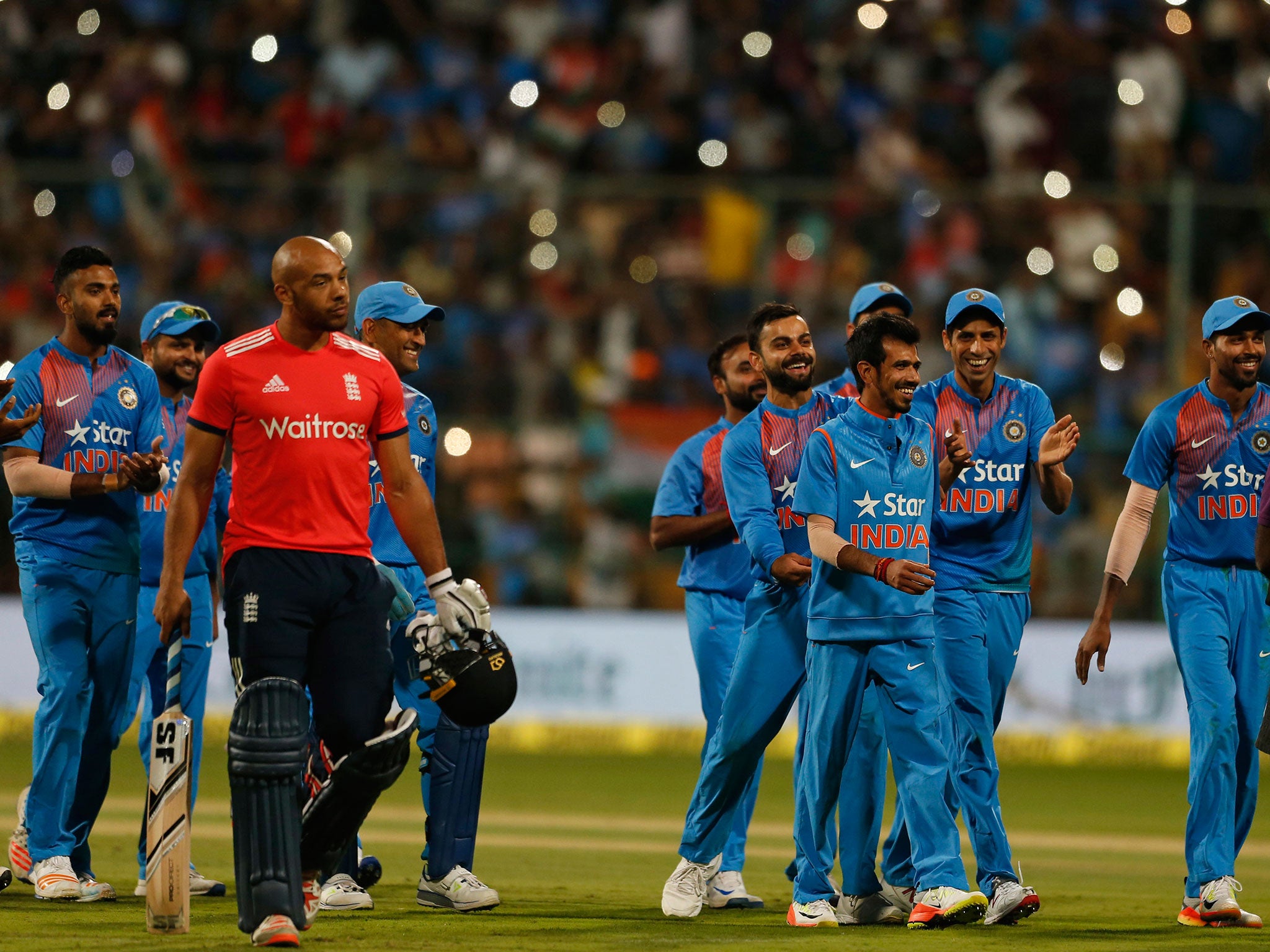 Indian cricketers celebrate their victory over England in their third Twenty20 international cricket match at Chinnaswamy Stadium in Bangalore,