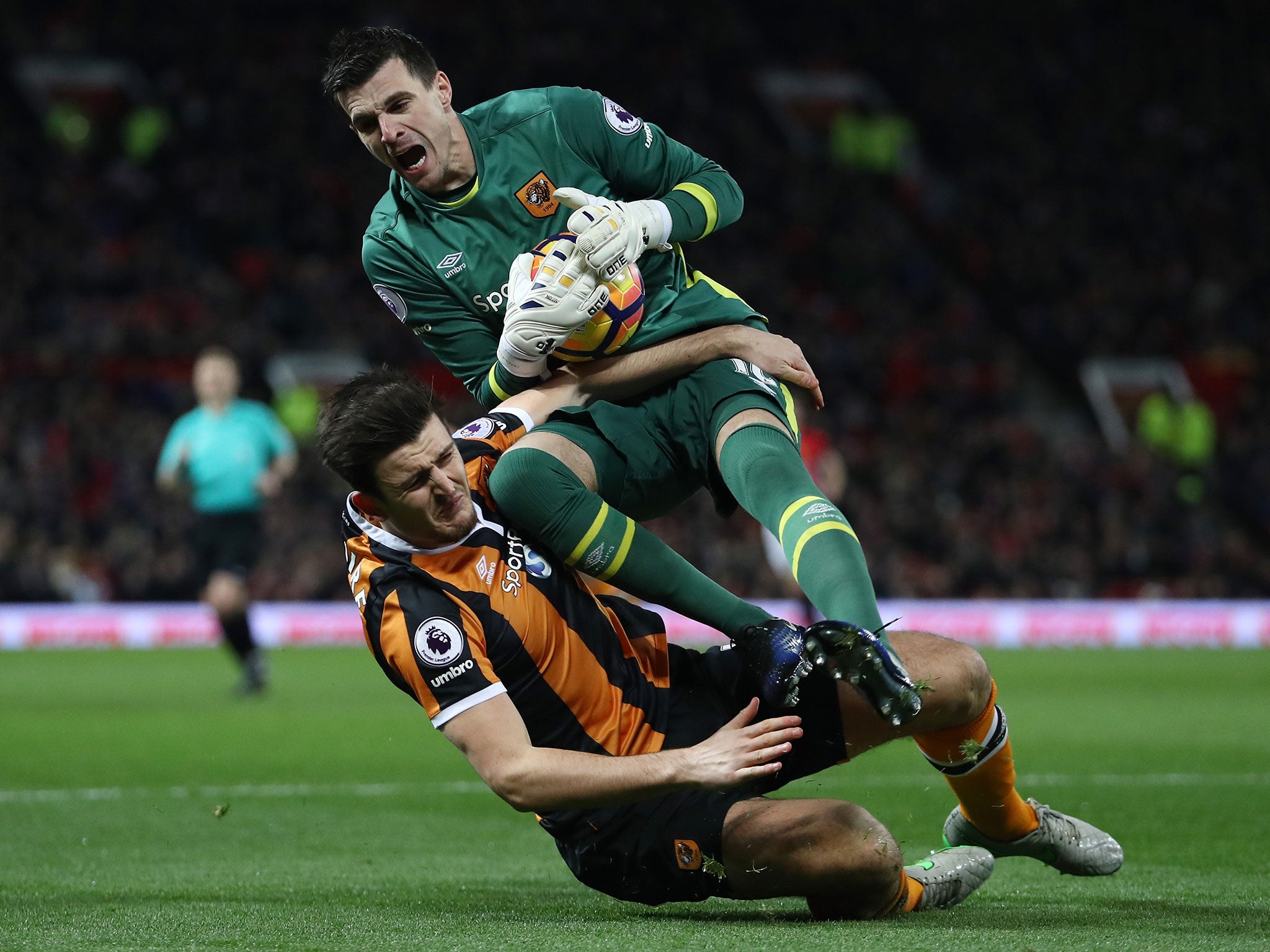 Eldin Jakupovic and Harry Maguire clash in the first half