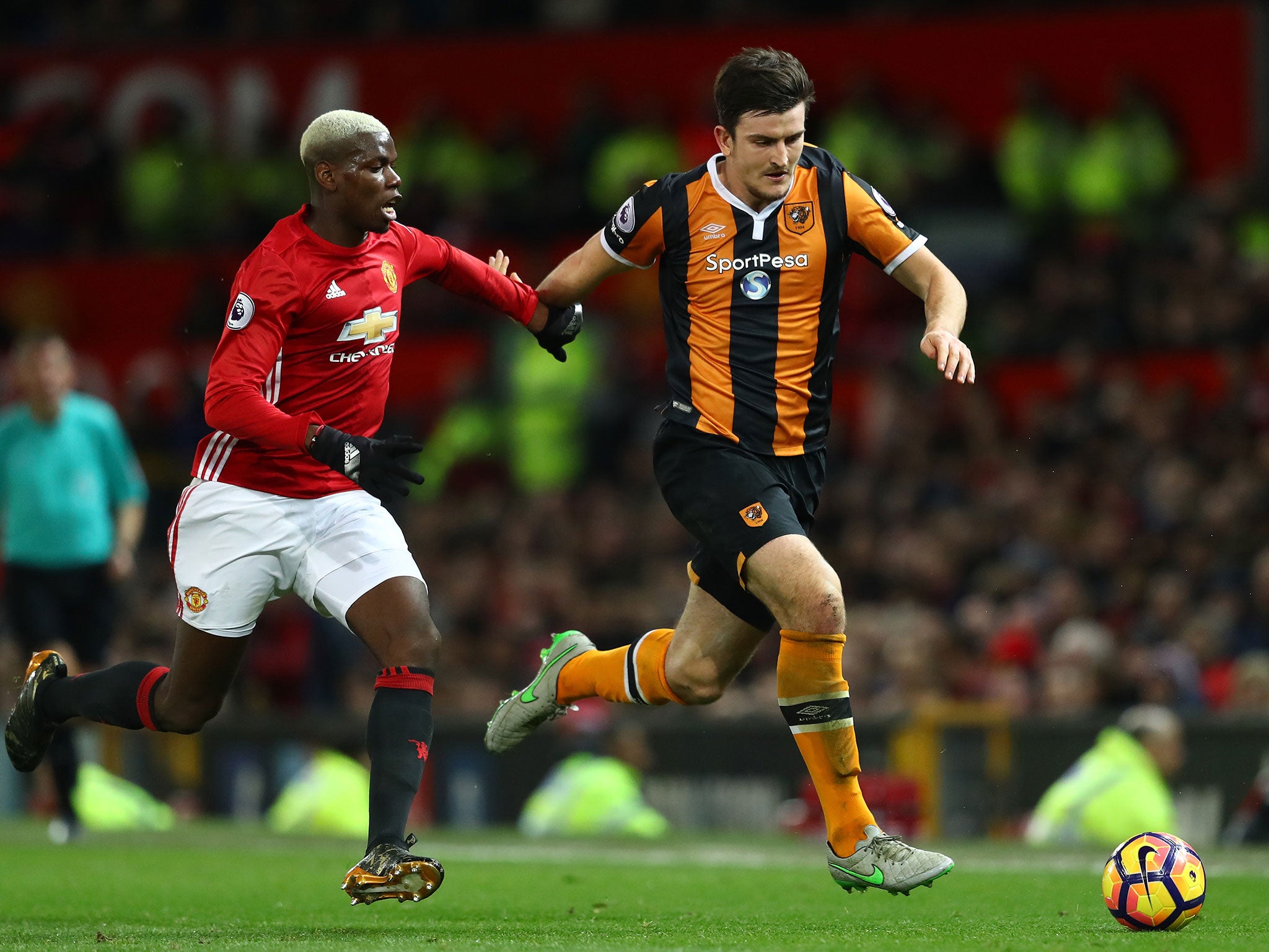 Paul Pogba gives chase to Hull's Harry Maguire