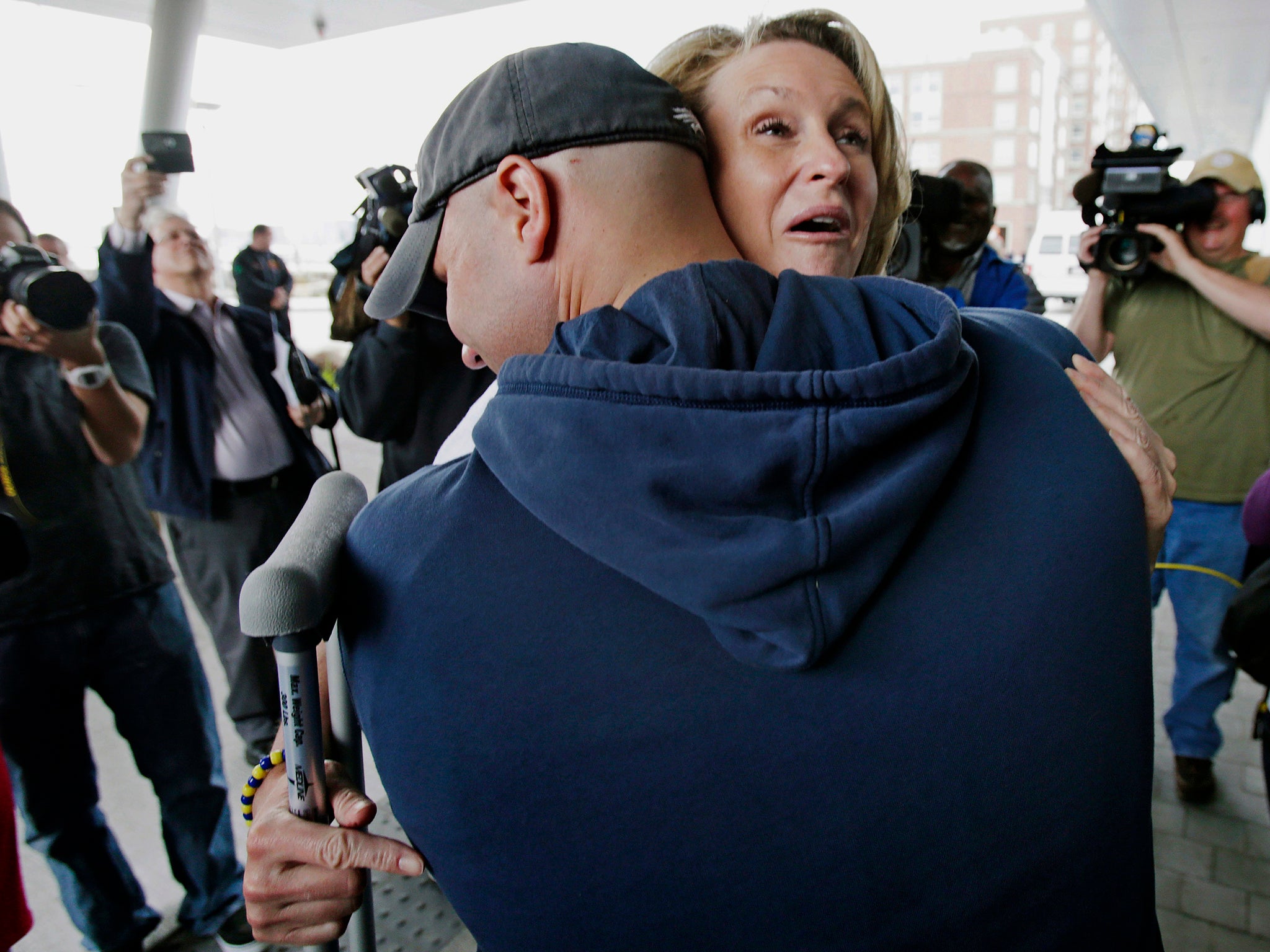 Survivor Roseann Sdoia is hugged and lifted off the ground by her firefighter fiance Mike Meteria as she leaves the Spaulding Rehabilitation Hospital in Boston