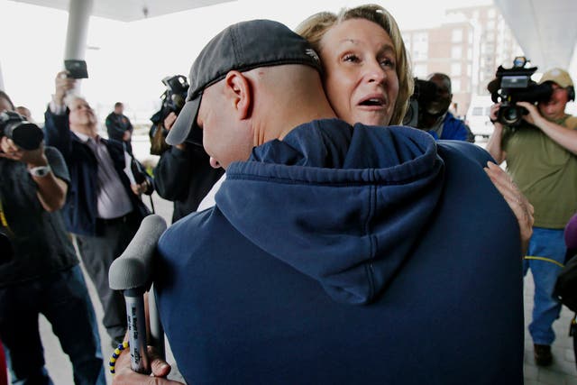 Survivor Roseann Sdoia is hugged and lifted off the ground by her firefighter fiance Mike Meteria as she leaves the Spaulding Rehabilitation Hospital in Boston