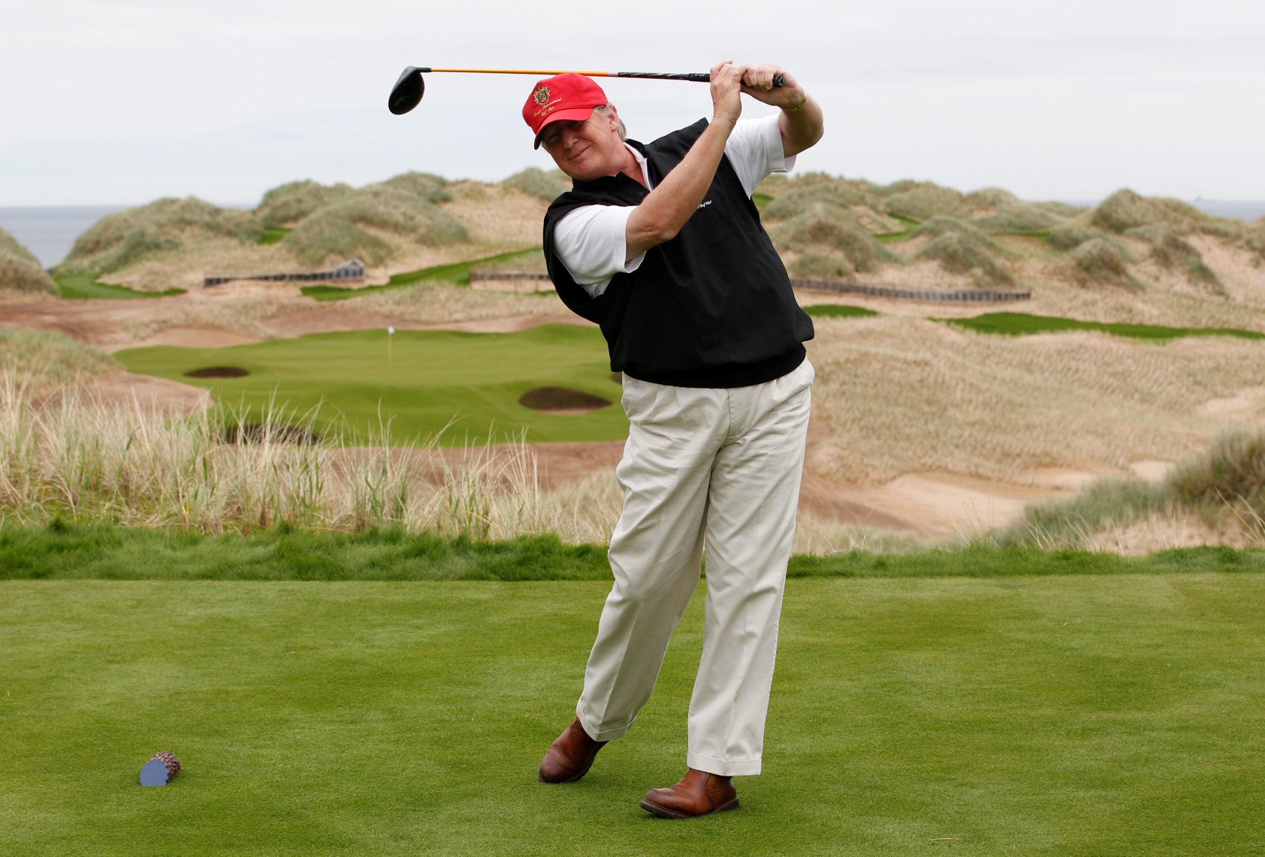 Donald Trump practices his swing at the Trump International Golf Links course on the Menie Estate near Aberdeen, Scotland