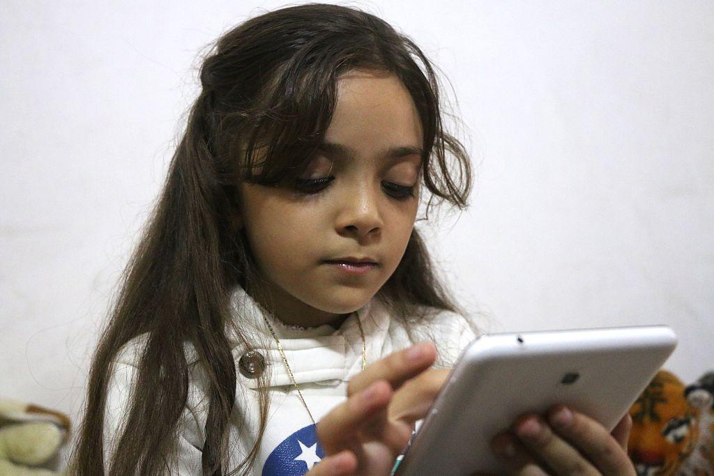 Bana Alabed using a tablet in east Aleppo on October 12 2016, before her family was granted asylum in Turkey