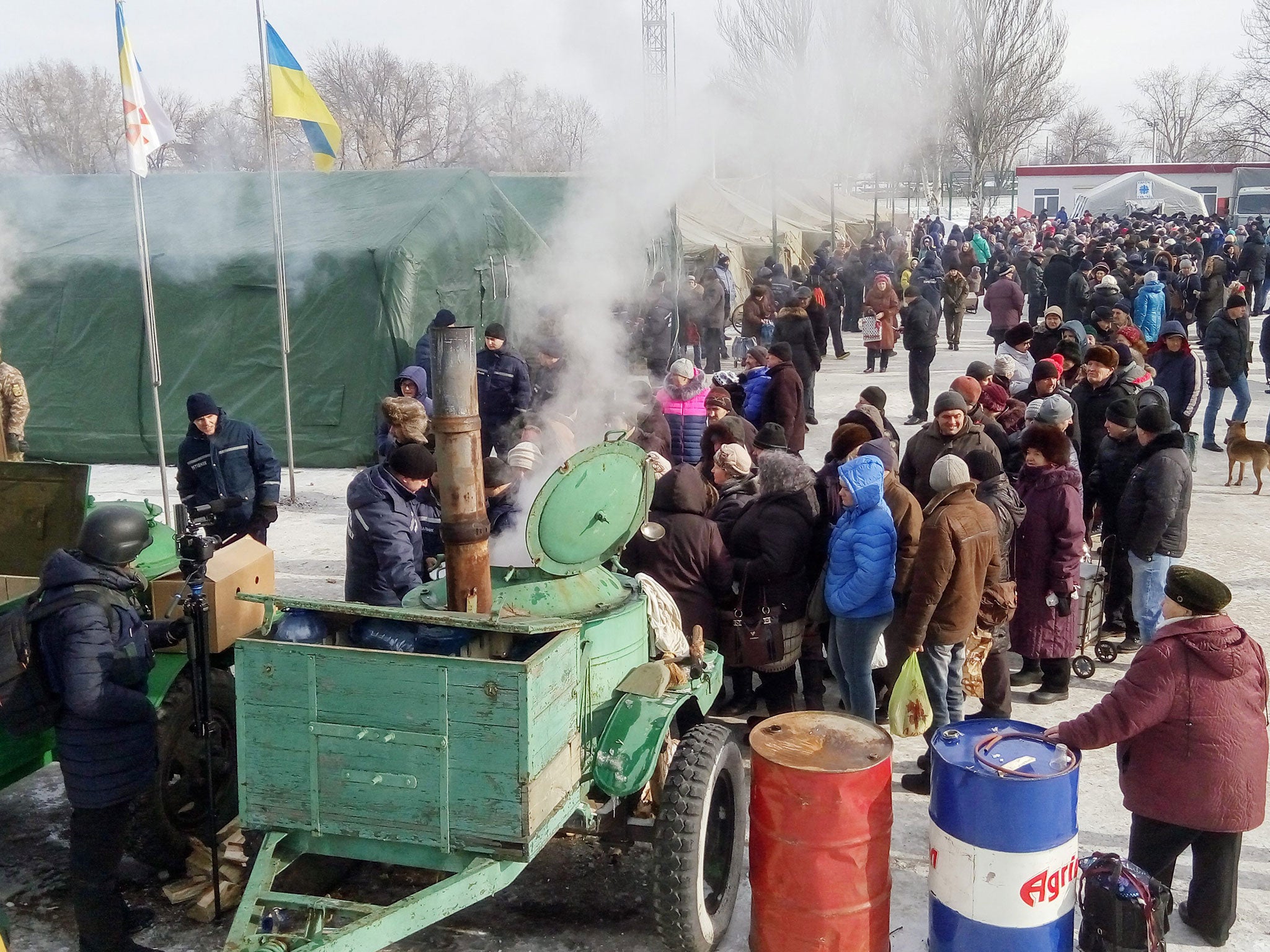 Ukrainian servicemen distribute hot food and tea to local citizens in Avdiivka